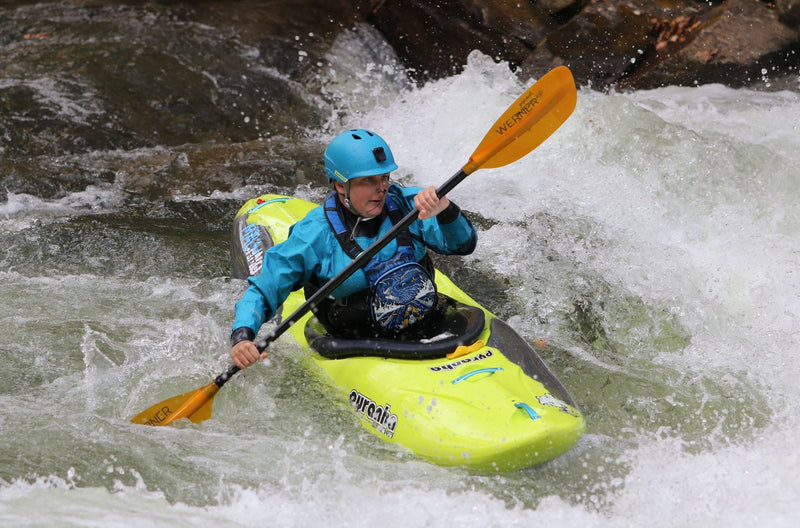 Beginner kayaker in her first whitewater kayak